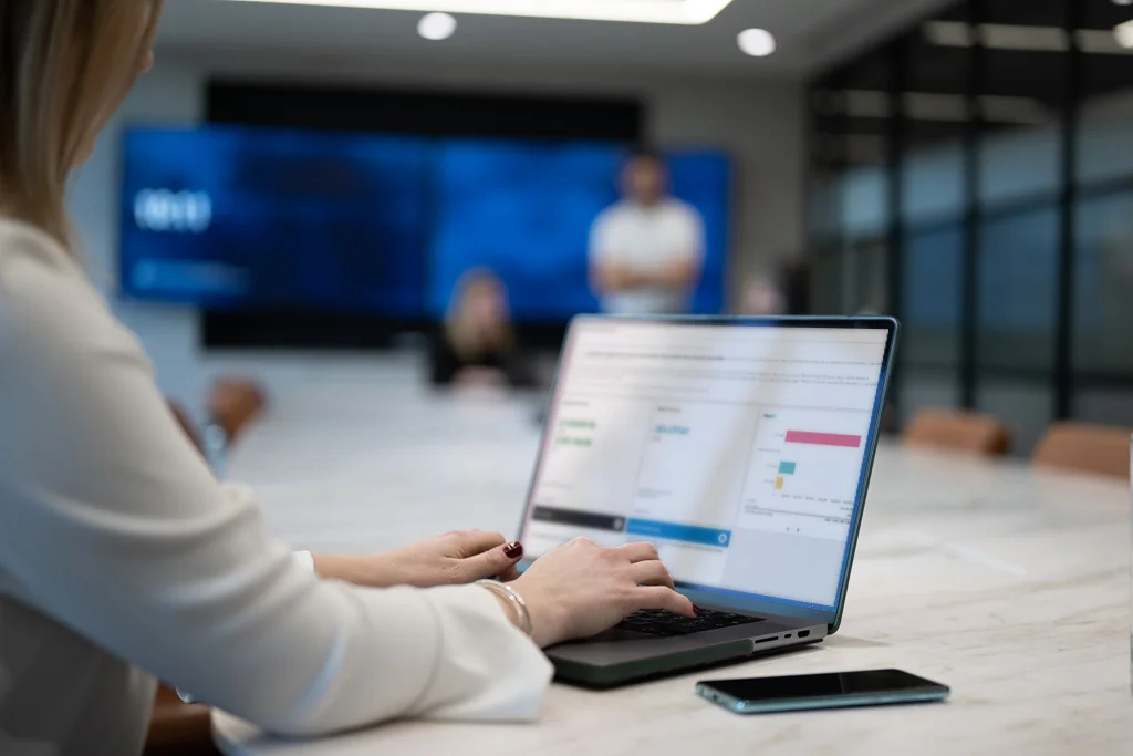 Person using a laptop to review payment analytics and business data during a meeting