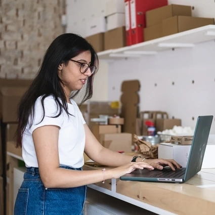 a lady with her laptop in store